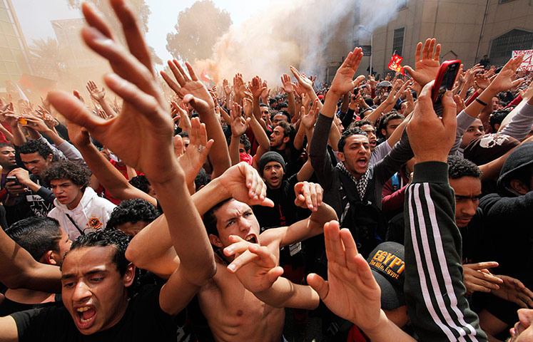 Al-Ahly fans celebrate in front of their club headquarters in Cairo, Egypt