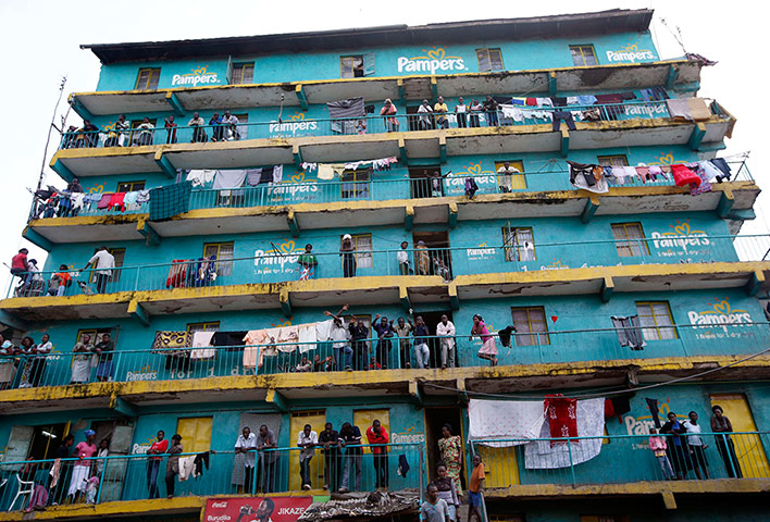 Supporters of the Kenyan prime minister, Raila Odinga, look out from the balconies of a building in the Mathare slum in Nairobi