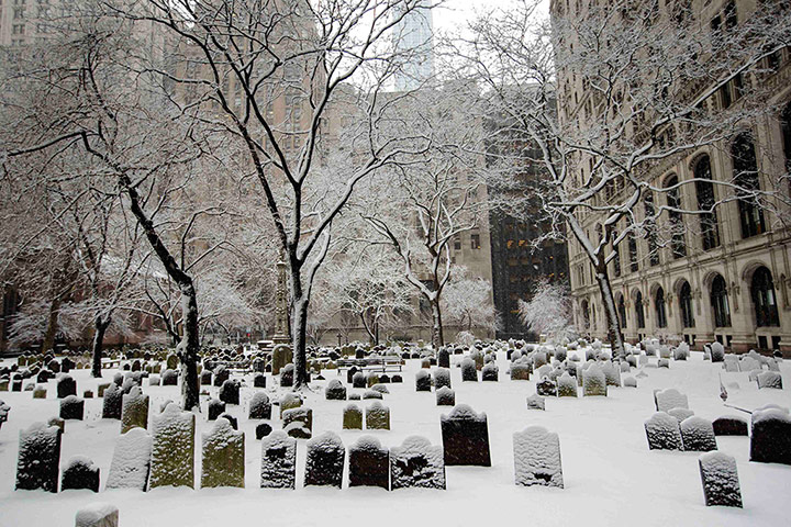 24 hours: Snow gathers on gravestones at the Trinity church in New York