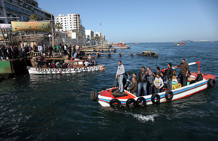 Port Said: Men ride in fishing boats to cross to the other side of the Suez Canal