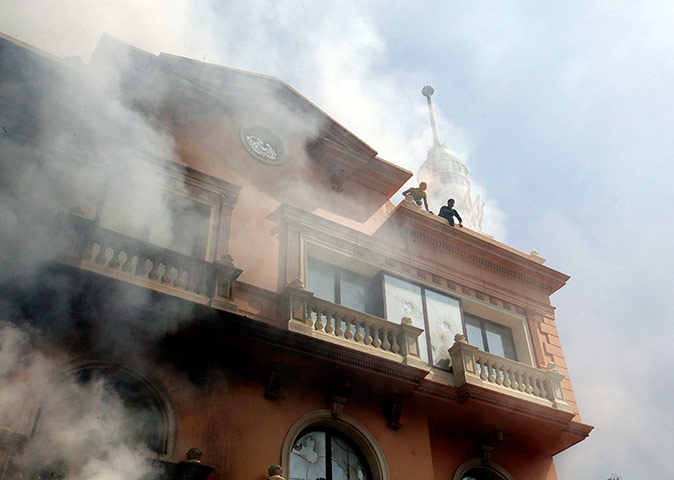 Port Said: Egyptian policemen wait to be rescued after a fire to a police cl