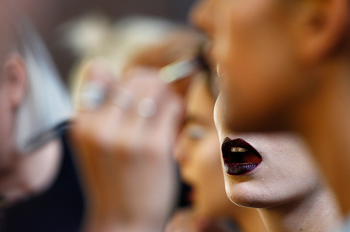 24 hours in pictures: Sydney, Australia: A model prepares backstage ahead of the Phoenix Keating 