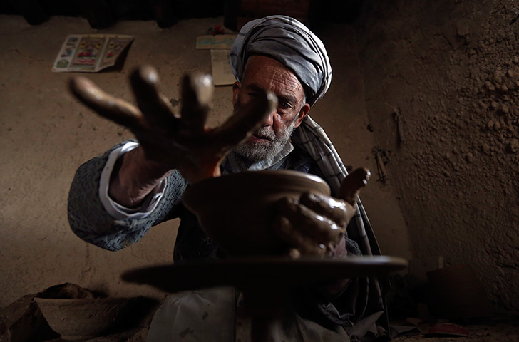 24 hours in pictures: An Afghan man makes a bowl from mud