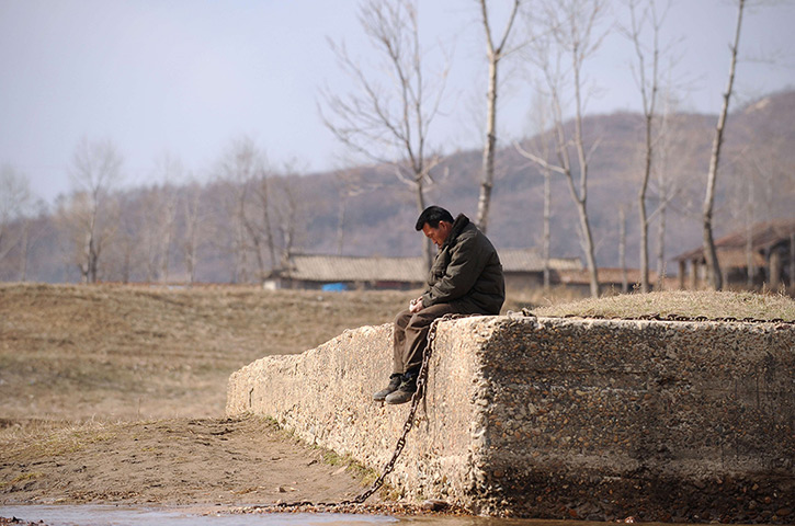 24 hours in pictures: A Korean man takes a rest on the banks of the Yalu River