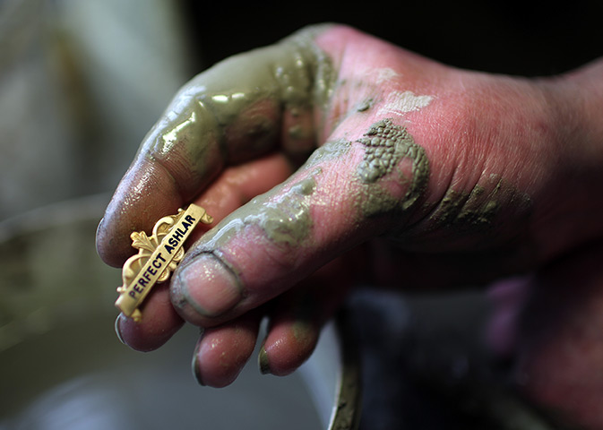 FTA: Christopher Furlong: A craftsman hand polishes a badge 