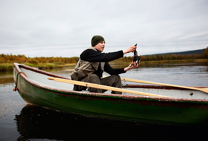 Cook it raw: A guide takes to the lake to retrieve one of Atala's kills