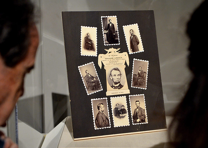 Civil war photography: People look at a display called In Memory of Abraham Lincoln, 1865