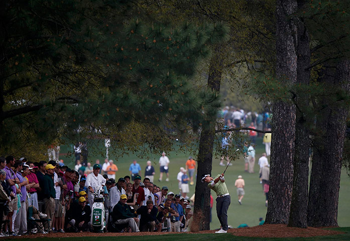 augusta day 1: Ryo Ishikawa of Japan hits his approach shot to the first green