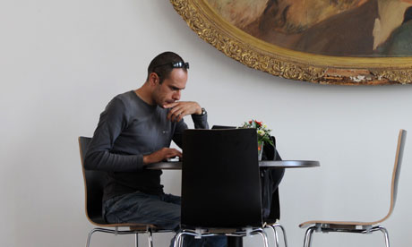 man with laptop in art gallery cafe