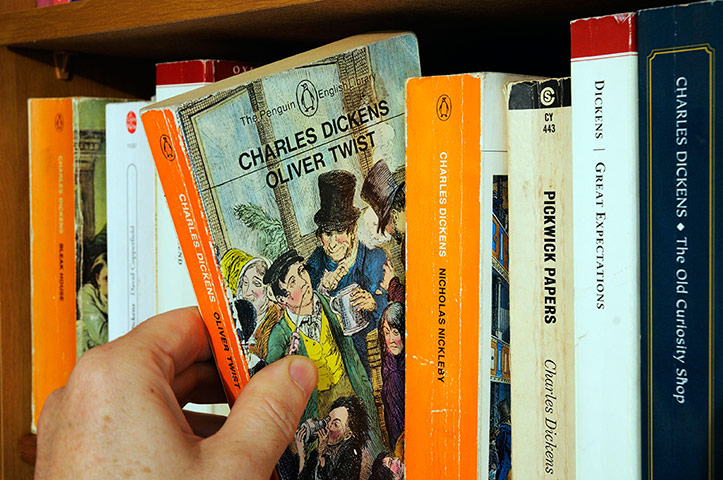 ALCS: Gallery: ALCS: A hand taking Charles Dickens Oliver Twist  from a bookshelf