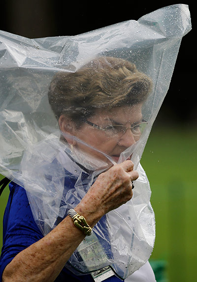 Augusta day 2: Fan protects herself from the rain