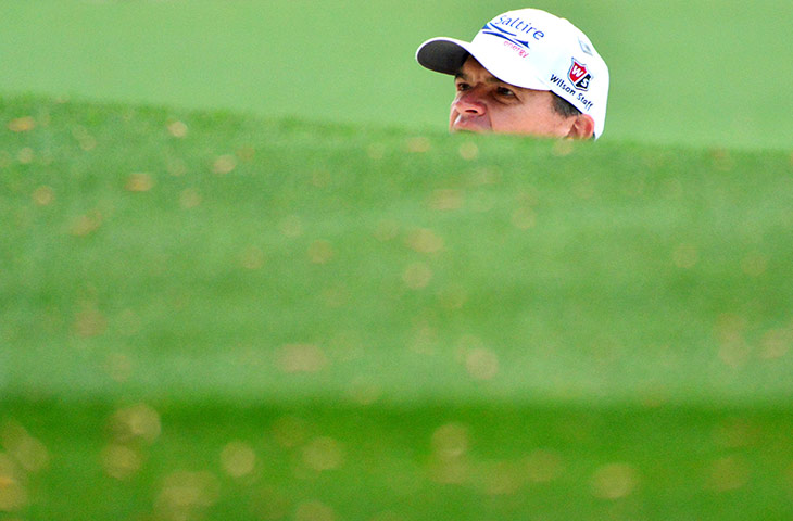 Augusta day 2: Paul Lawrie checks his lie on the first green