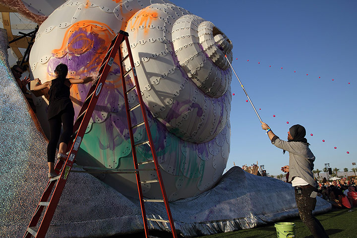 Coachella: Artists paint a giant snail statue at the Festival in Indio, California