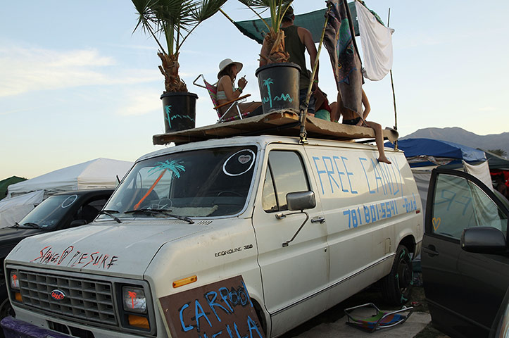 Coachella: Coachella music fans look out over the festival from atop a van