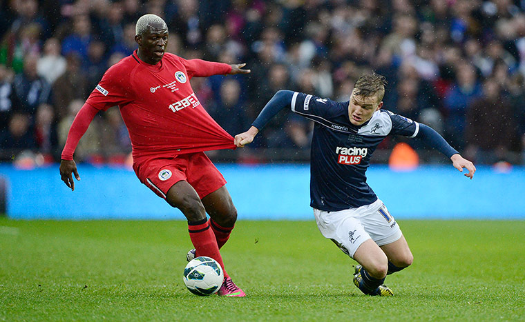 FA Cup semi: Millwall player Shane Lowry pulls the shirt of Arouna Kone of Wigan 