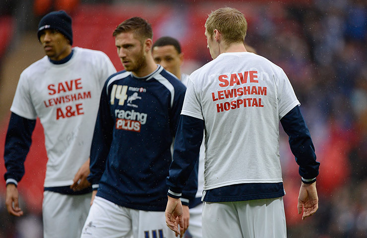 FA Cup semi: Millwall players warm up in t-shirts supporting Lewisham hospital
