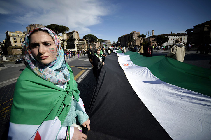 24 hours: Rome, Italy: Demonstrators hold a large Syrian National Coalition flag