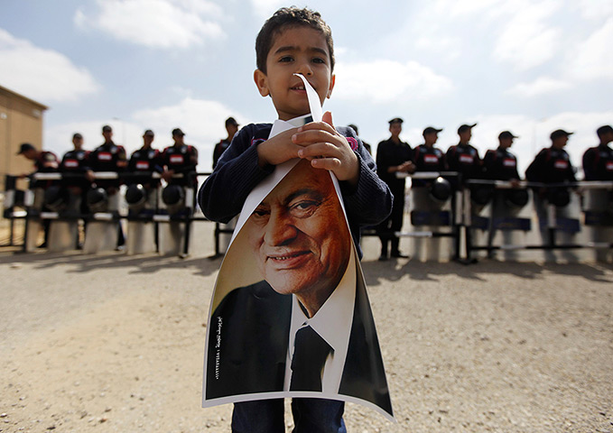 24 hours: Cairo, Egypt: A boy holds a picture of Hosni Mubarak