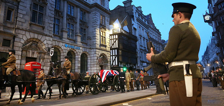 Rehearsal: A flag-draped coffin is carried on a gun carriage 