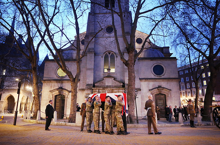 Rehearsal: A flag-draped coffin is carried on a gun carriage past St Clement Danes Chu