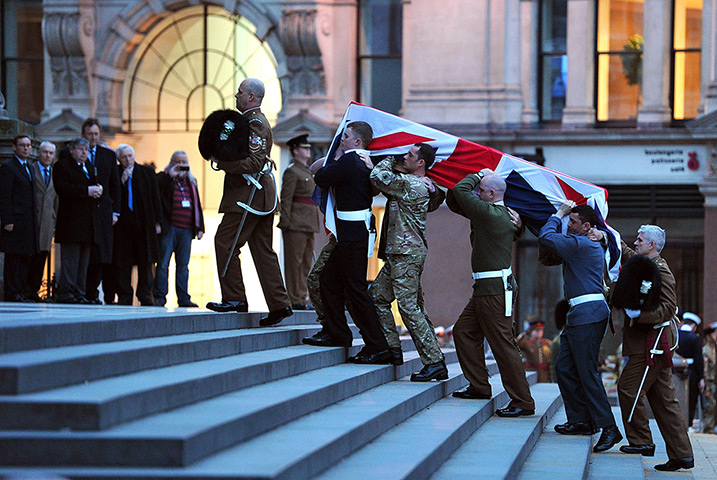 Rehearsal: Bearer Party from the three military services carry a coffin up the steps o