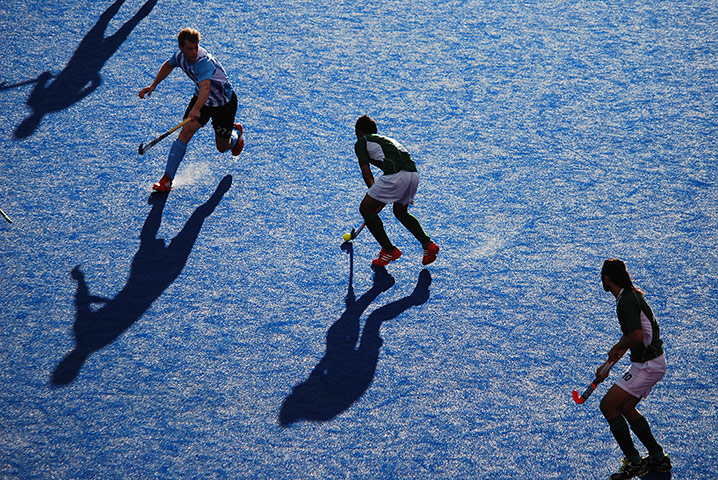 Your Pictures - parallel: men playing hockey on blue surface