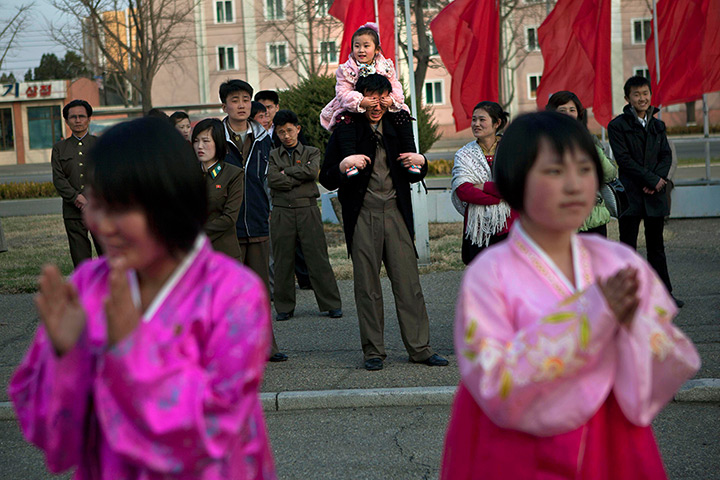 24 hours: Pyongyang, North Korea: A child covers her father's eyes