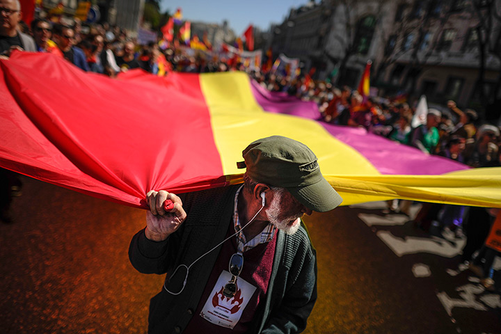 24 hours: Madrid, Spain: People hold a giant flag during a demonstration