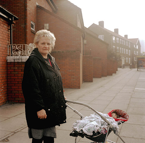 Big Picture - Rob Bremner: woman standing next to a pushchair in bleak housing estate