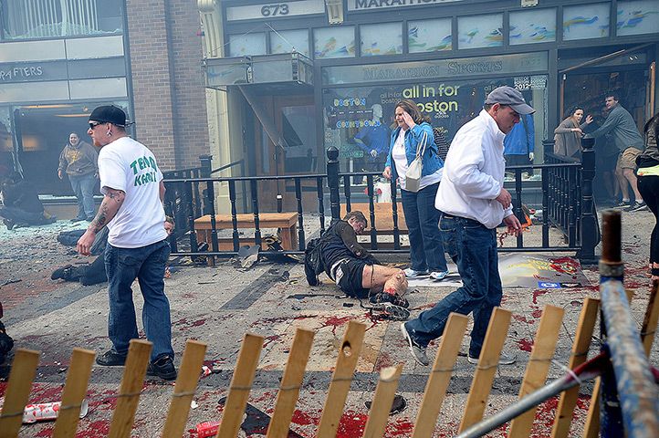 Boston explosions update: Injured people and debris lie on the sidewalk near the finish line