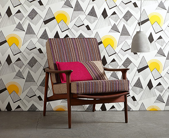Homes - Chairs: upholstered vintage chair against a yellow and black wallpapered background