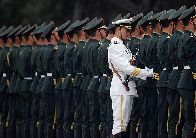 24 hours in pictures: Beijing, China: A member of the People's Liberation Army's navy guard of ho