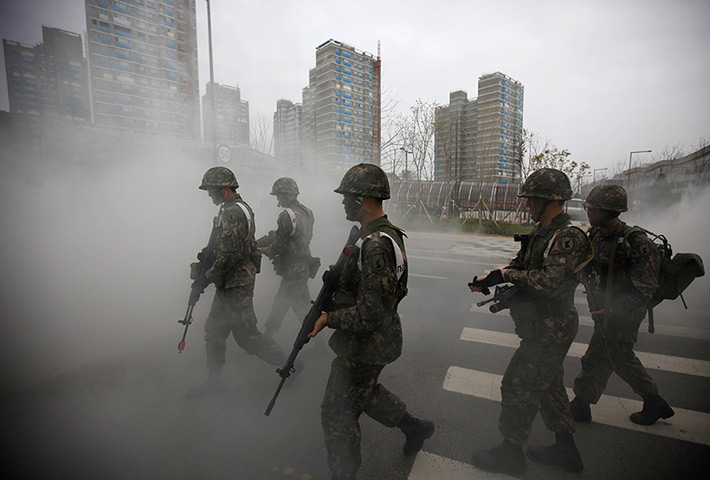 24 hours: Sejong, South Korea: Soldiers walk through smoke