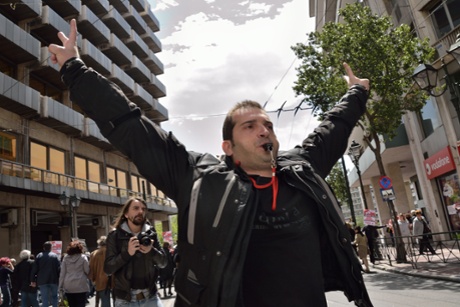 A demonstrator is seen making noise with a whistle.