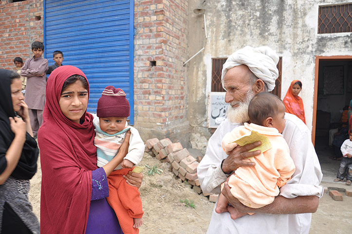 Three generations of a family turn up for a vaccination session in the village of Chinkowindi, Pakistan