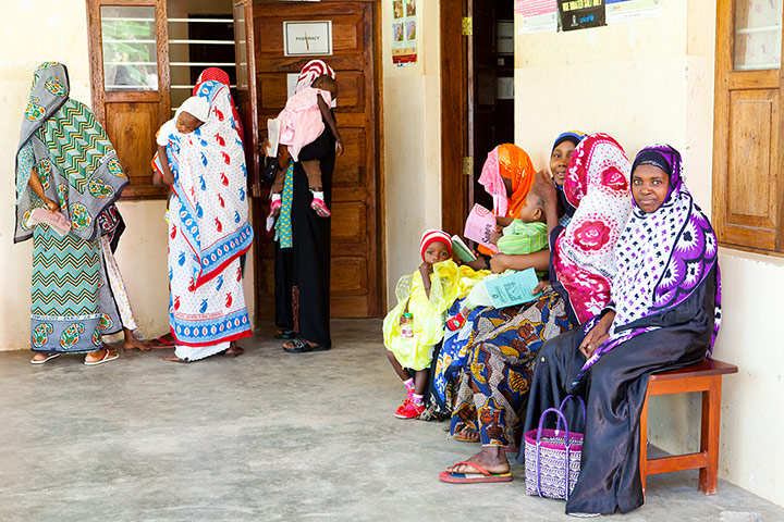 Mothers wait at a health clinic in Zanzibar for their children to receive vaccines