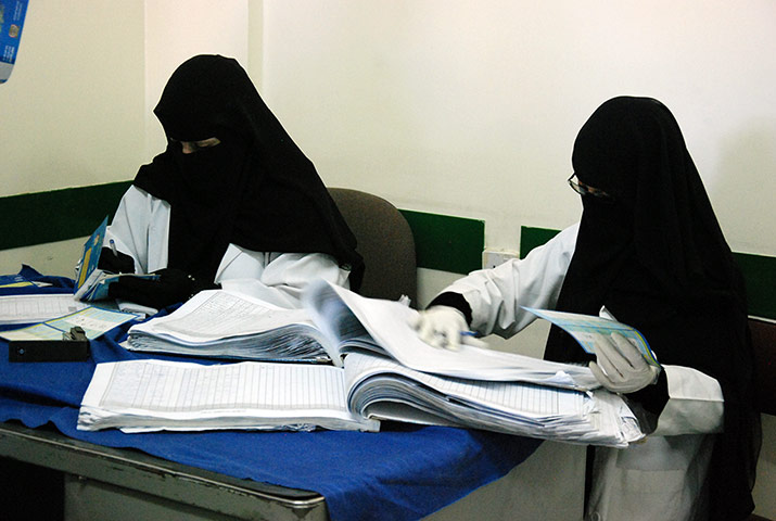 Health workers at the Zahwari Medical Centre in Yemen register vaccination cards