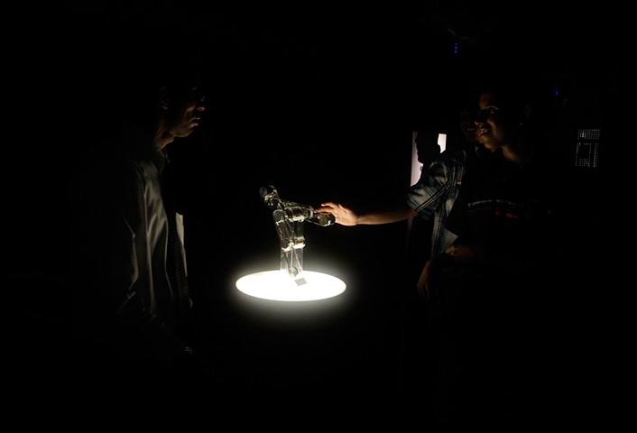24 hours: Lima, Peru: Students touch a robot at The Science Tunnel exhibition at the 