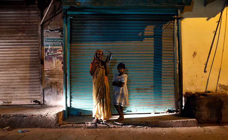 24 hours: New Delhi, India: A woman speaks on a phone
