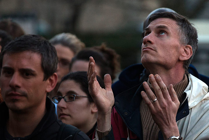 boston service: A man raises his hands