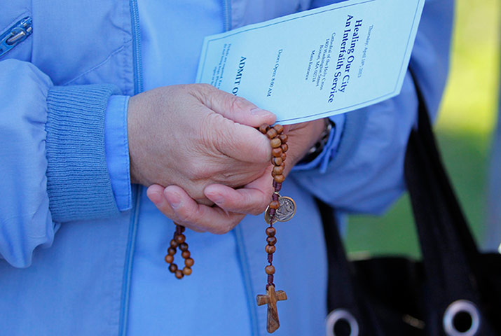 boston service: A nun holds a pair of rosary beads