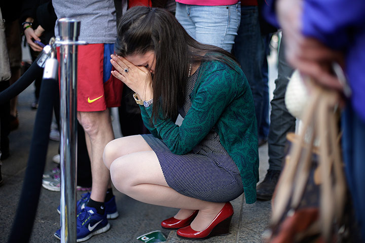 24 hours in pictures: A woman prays near a makeshift memorial