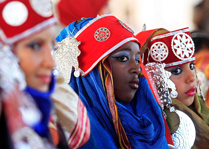 24 hours in pictures: Girls wearing folk costumes participate in a carnival in Benghazi