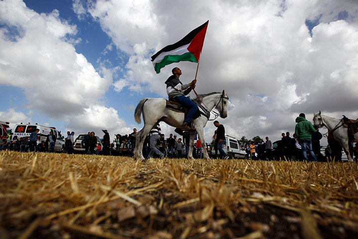 20 Photos: An Arab-Israeli protester on a horse holds a Palestinian flag 