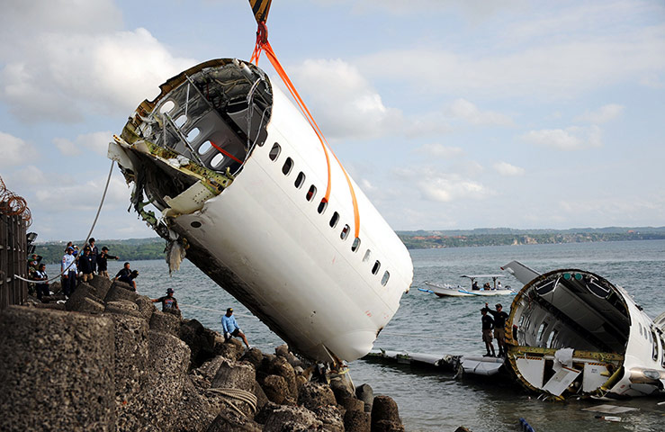 20 Photos: Indonesian rescue workers help remove a section of a Lion Air Boeing 737
