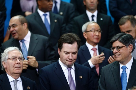 Britain Chancellor of the Exchequer George Osborne, center, stands with Bank of England Gov. Mervyn King, left, and U.S. Treasury Secretary Jack Lew during a group photo of the G20 finance ministers and central bank governors on the sidelines of their meeting at World Bank Group International Monetary Fund Spring Meetings in Washington, Friday, April 19, 2013.