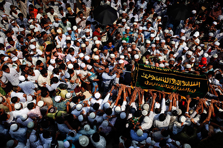 24 hours in pictures: Rangoon, Burma: People carry a coffin during a funeral for the victims of a