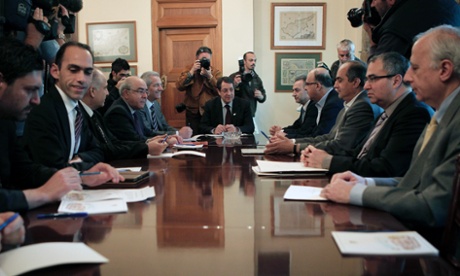 Cyprus' new finance minister Harris Georgiades, second from left, in a meeting ahead of the country's bailout.