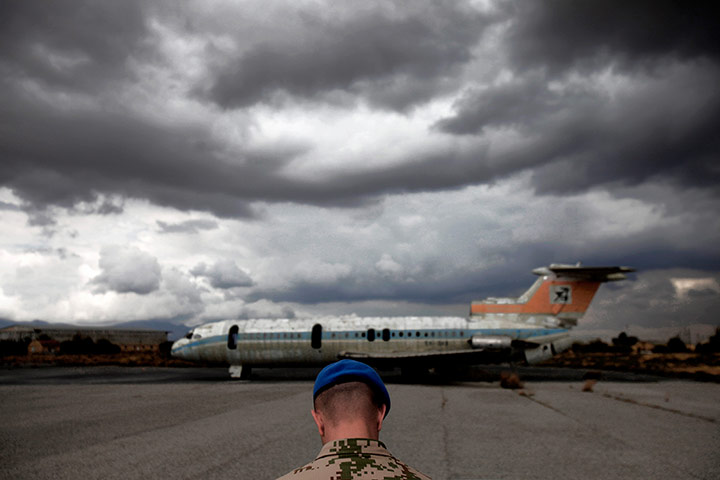 24 Hours: A UN soldier stands in front of an destroyed Cyprus Airways in Nicosia