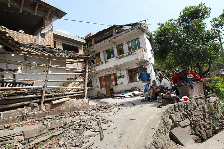 China: Residents rest outside damaged houses in Longmen township